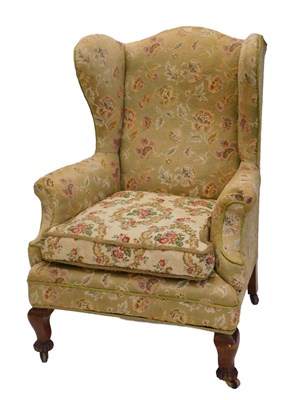 Lot 965 - A mahogany wingback chair, in mid 18thC style,...