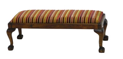 Lot 1175 - A mahogany fender stool, with striped padded...