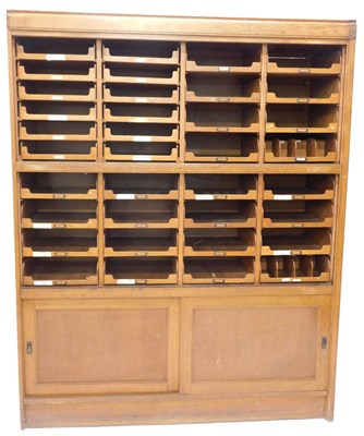 Lot 1178 - An oak haberdasher's shop cabinet, with...