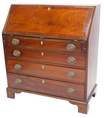 Lot 1180 - A George III mahogany bureau, the cross banded...
