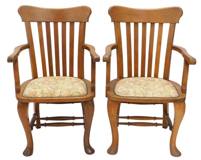 Lot 1247 - A pair of early 20thC oak open armchairs, each...
