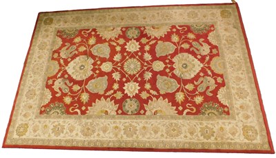 Lot 1253 - A machine woven rug, decorated with a design...
