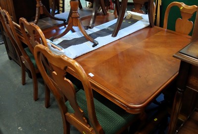 Lot 1555 - A hardwood extending dining table, 74cm high,...