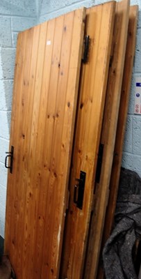 Lot 1661 - Four pine plank doors, with metal latches and...