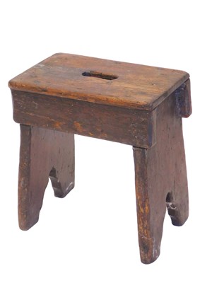 Lot 1229 - A small pine stool, with a pierced carrying...