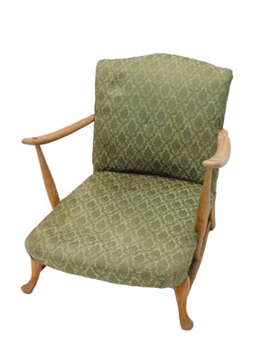 Lot 1241 - An Ercol type beech low open armchair, with a...