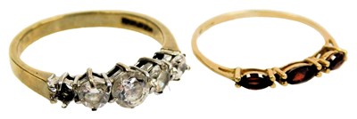 Lot 212 - A 9ct gold and garnet three stone ring, size K,...