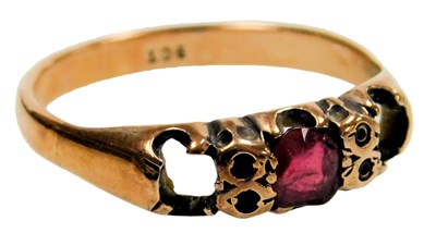 Lot 209 - A three stone ring, set with a central ruby,...