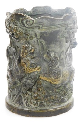 Lot 81 - A Chinese bronze brush pot, relief decorated...