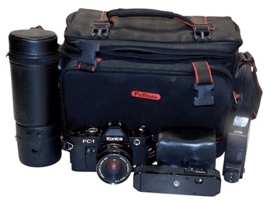 Lot 192 - A Konica FC-1 camera, an auto winder, flash,...