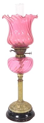Lot 196 - A Victorian brass oil lamp, with a cranberry...