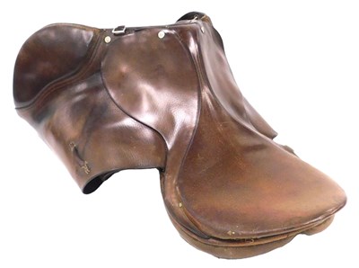 Lot 243 - A tan leather saddle, 69cm deep.