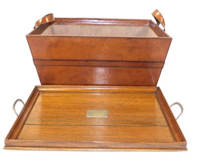 Lot 254 - A tan leather crate, with leather handles,...