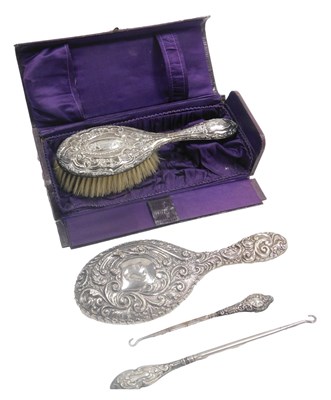 Lot 527 - A George V silver backed hand mirror and hair...
