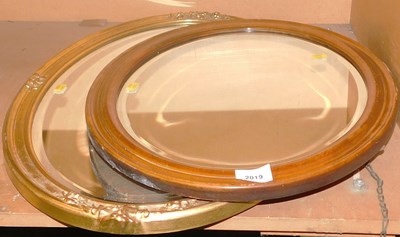 Lot 2019 - A gilt framed oval wall mirror, with floral...