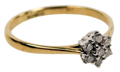 Lot 411 - A 9ct gold and diamond seven stone flower head...