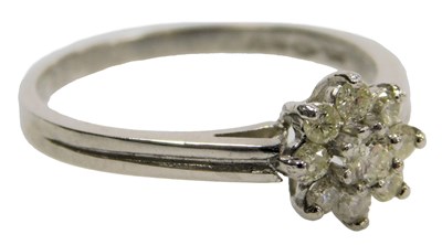 Lot 415 - A platinum and diamond nine stone flower head...