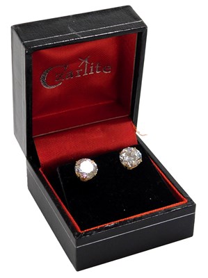 Lot 419 - A pair of cz solitaire earrings, in yellow...