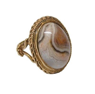 Lot 62 - A 9ct gold and agate ring, the central...