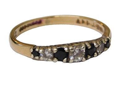 Lot 65 - A 9ct gold CZ and sapphire ring, the three CZ...