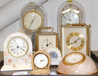 Lot 2103 - Two Kundo anniversary clocks, each in a glass...