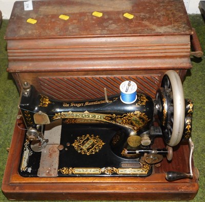 Lot 2140 - A Singer oak cased sewing machine.