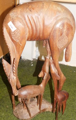 Lot 2141 - A hardwood carving depicting a deer with fawns,...