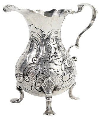 Lot 77 - A 19thC silver cream jug, embossed with...