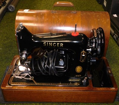 Lot 2210 - A cased Singer sewing machine.
