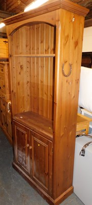 Lot 1004 - A pine bookcase, the top with a moulded edge...