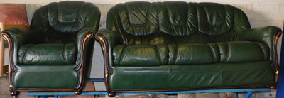 Lot 1096 - A green leather upholstered three seater sofa,...
