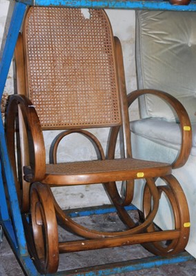 Lot 1084 - A bentwood rocking chair, with caned seat and...