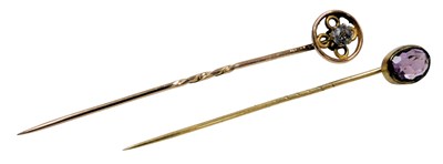 Lot 543 - An amethyst set tie pin, in yellow metal, and...