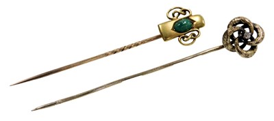 Lot 546 - A Victorian diamond set stick pin, in a scroll...