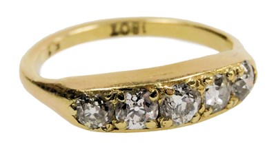 Lot 535 - A diamond five stone ring, in a rub over...