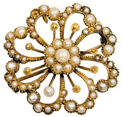 Lot 556 - An Edwardian seed pearl set circular floral...