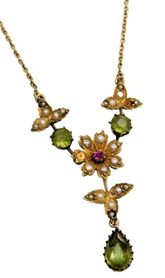 Lot 557 - An Edwardian peridot seed pearl and ruby...