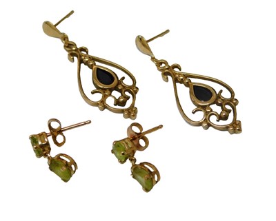 Lot 219 - A pair of garnet drop earrings, of scrolling...