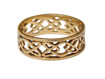 Lot 211 - A wedding band, pierced Celtic knot form,...