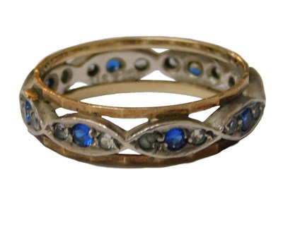 Lot 213 - An eternity band, set with white and blue...