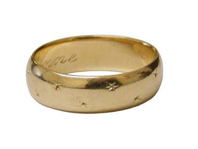 Lot 202 - A wedding band, engraved with star motifs,...