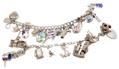 Lot 579 - A silver charm bracelet, with eleven charms as...