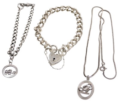 Lot 581 - A silver curb link bracelet, on a heart shaped...