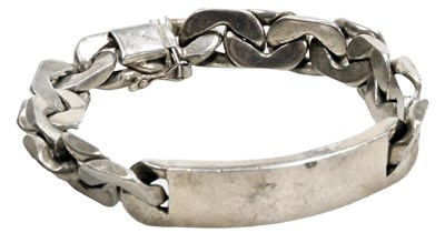 Lot 585 - A curb link identity bracelet, on a snap clasp,...