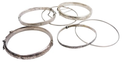 Lot 574 - Two silver bangles, with engraved decoration,...