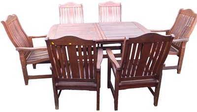 Lot 736 - A wooden extending garden dining table, raised...