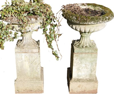 Lot 739 - A pair of stone garden urns, of semi fluted...