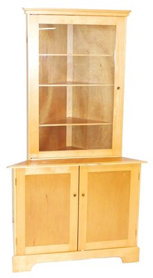 Lot 703 - A beech and teak corner cabinet, with an...
