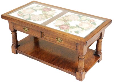 Lot 767 - An oak coffee table, with a glass protected...