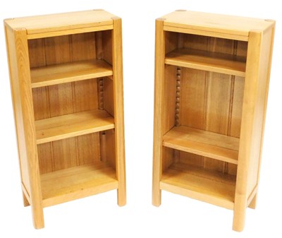 Lot 780 - A pair of light oak bookcases, with a carved...